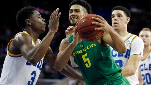 Oregon’s Tyler Dorsey (5) drives to the basket against UCLA’s Aaron Holiday (3) and Lonzo Ball (2) in the second half at Pauley Pavilion in Los Angeles on Thursday, Feb. 9, 2017. (Gary Coronado/Los Angeles Times/TNS)