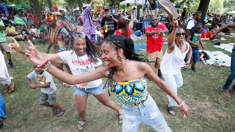 Aaliyah Simmons (center) and festivalgoers enjoy the DJ's tunes during the 31st annual Malcolm X Festival at West End Park in Atlanta on Sunday, May 22, 2022. (Photo: Miguel Martinez / miguel.martinezjimenez@ajc.com)