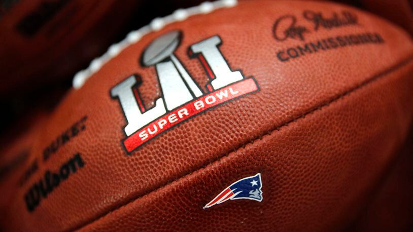 The New England Patriots' NFL Super Bowl LI game ball is finished with the team's logo affixed to it at the Wilson Sporting Goods factory Monday, Jan. 23, 2017, in Ada, Ohio.