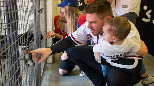 Atlanta Braves baseball player Freddie Freeman held his son Charlie (age 2) as they met dogs during a visit to Best Friends in Atlanta as part of the team's Season of Giving on Wednesday, Dec. 12th, 2018. The animal shelter works collaboratively with area shelters, animal welfare organizations and individuals to save the lives of pets in shelters. (Photo by Phil Skinner)