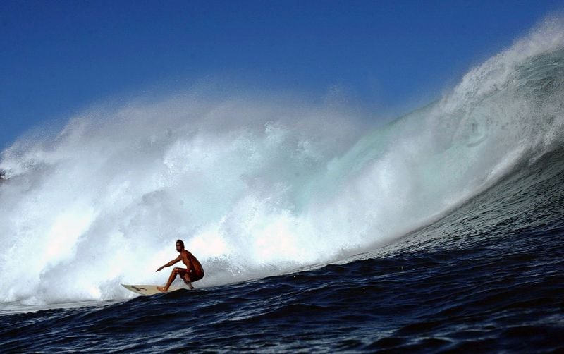   Surfer Rob Burns drops into a large wave during a large swell on January 10, 2004 at Windmills in Kapalua, Maui, Hawaii. (Photo by Donald Miralle/Getty Images)