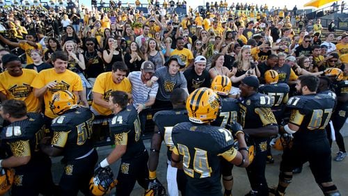 Kennesaw State University football players celebrate with the student section after their inagural win over Edward Waters at Fifth Third Bank Stadium on Sept. 12, 2015. The score of the first home game ever was 58-7.