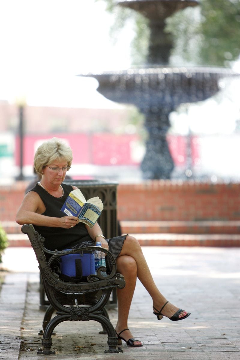 Aug. 13, 2007: Pam Burel found a shady spot on Marietta Square to read during her lunch break. While it was hot, it wasn't nearly as hot as last week, and it was "too cold" inside, she said.