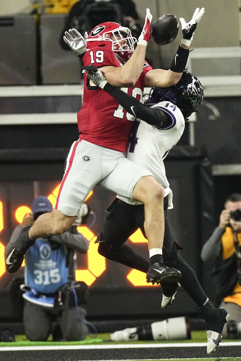 FILE - Georgia tight end Brock Bowers (19) makes a touchdown catch against TCU safety Abraham Camara (14) during the second half of the national championship NCAA College Football Playoff game, Monday, Jan. 9, 2023, in Inglewood, Calif. As he showed in three seasons at Georgia, Bowers is a dynamic receiver with the ability to create separation, make contested catches and create big plays after the catch, along with being a more than capable blocker.(AP Photo/Mark J. Terrill, File)