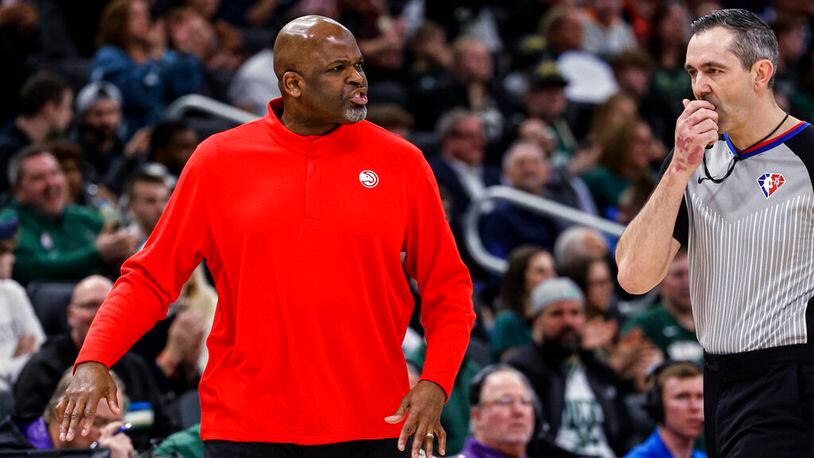 Hawks coach Nate McMillan is called for a technical foul by referee Brett Nansel during the team's game against the Milwaukee Bucks on Wednesday night. (AP Photo/Jeffrey Phelps)