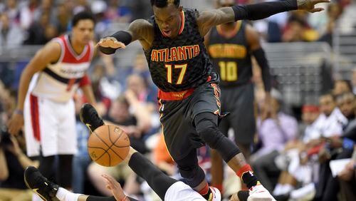 Atlanta Hawks guard Dennis Schroder (17), of Germany, battles for the ball against Washington Wizards guard Garrett Temple, bottom, during the first half of an NBA basketball game, Wednesday, April 13, 2016, in Washington. (AP Photo/Nick Wass)