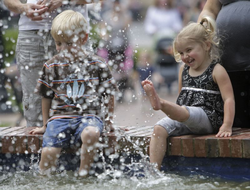 May 13, 2010: Bella Simmons splashes in the renovated fountain with Daniel Horne, both 3-year-olds from Marietta. The fountain and Marietta Square had just undergone renovations and repairs.