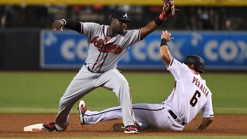 PHOENIX, AZ - JULY 24: Brandon Phillips #4 of the Atlanta Braves makes the out on David Peralta #6 of the Arizona Diamondbacks at second base during the first inning at Chase Field on July 24, 2017 in Phoenix, Arizona. (Photo by Norm Hall/Getty Images)