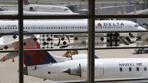FILE - In this Monday, Aug. 8, 2016, file photo, Delta Air Lines planes are parked at Ronald Reagan Washington National Airport, in Washington. A California family says they were forced off a Delta plane and threatened with jail after refusing to give up one of their children's seats on a crowded flight. A video of the April 23, 2017, incident was uploaded to Facebook on Wednesday, May 3, 2017, and adds to the list of recent encounters on airlines that went viral, including the dragging of a passenger off a United Express plane. (AP Photo/Carolyn Kaster, File)