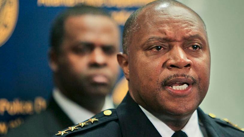 Mayor Kasim Reed listens to Atlanta Police Department Chief George Turner announce on Monday, Feb. 7, 2011, that he is disbanding the controversial Red Dog narcotics unit.