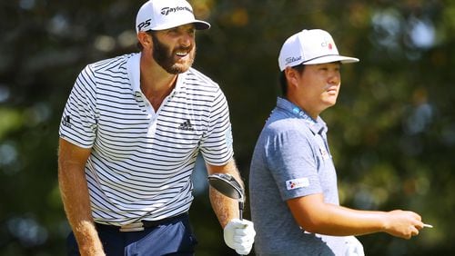 Early leader Dustin Johnson watches his drive off the fifth tee while Sungjae Im prepares to tee off during their third round of the Tour Championship Sunday, Sept. 6, 2020, at East Lake Golf Club in Atlanta.