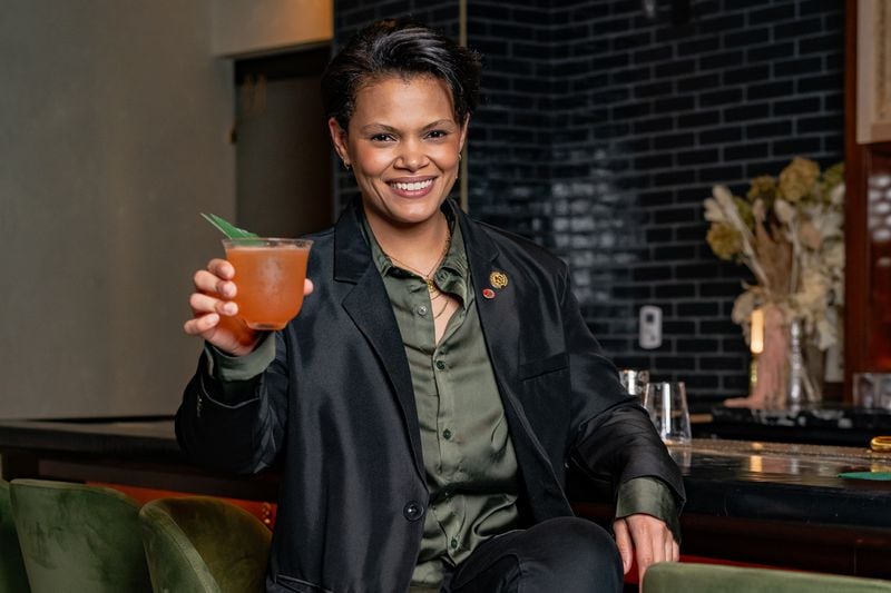 Mona Allen toasts a favorite new cocktail she created, the Panda Panda Panda, made with mezcal, Tattersall sour cherry liqueur, lime and yuzu. (Jason Allen/Atlanta Journal-Constitution)