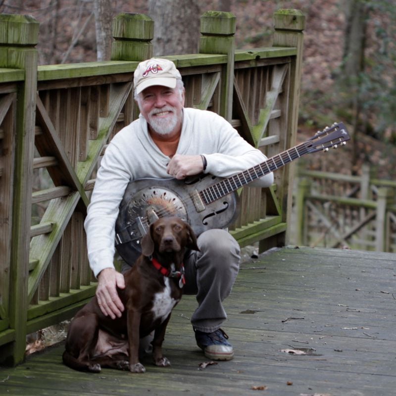 A promotional photograph of singer-songwriter John McCutcheon, pictured here with his dog Maybelle. 
Courtesy of Eric Peterson.