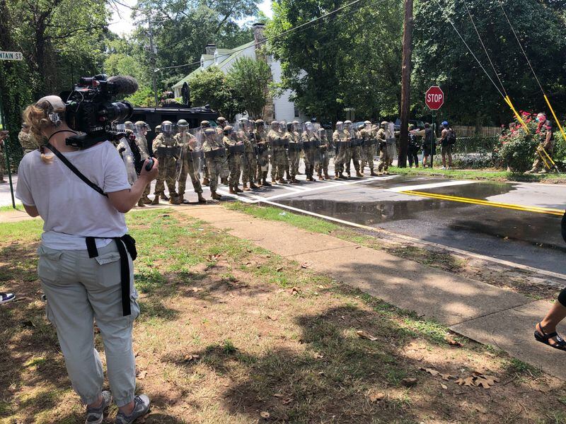 Saturday, Aug. 15, 2020, Stone Mountain -- Police officers move through the streets of Stone Mountain to disperse demonstrators.