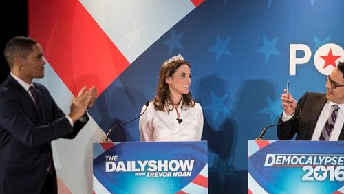 Ryan Lizza, Washington Correspondent for The New Yorker, (right) takes a picture of Alicia Menendez, (center) as Trevor Noah applauds during Comedy Central's "The Daily Show with Trevor Noah" Presents "Podium Pandemonium: A Debate About Debates," in February of 2016.