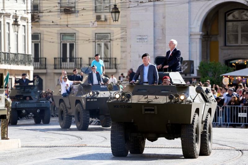Military vehicles that took part in the 1974 Carnation revolution, some carrying retired soldiers, parade at Lisbon's Comercio square, Thursday, April 25, 2024, during celebrations of the fiftieth anniversary of the military coup. The April 25, 1974 revolution carried out by the army restored democracy in Portugal after 48 years of a fascist dictatorship. (AP Photo/Armando Franca)