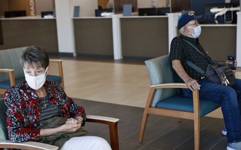 Judith Cripps (left) sits in the waiting area next to her husband Bill Cripps, a 13 year Navy veteran (right) at the Cobb County Veteran Affairs Clinic in Marietta on Monday, September 26, 2022. (Natrice Miller/natrice.miller@ajc.com)  