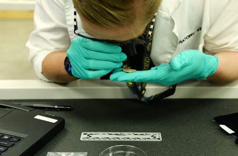 Dr. Traci Van Deest, a forensic anthropologist, analyzes material evidence inside the Defense POW/MIA Accounting Agency Offutt Laboratory in 2019 at Offutt AFB, Nebraska. (U.S. Air Force photo by Charles J. Haymond)