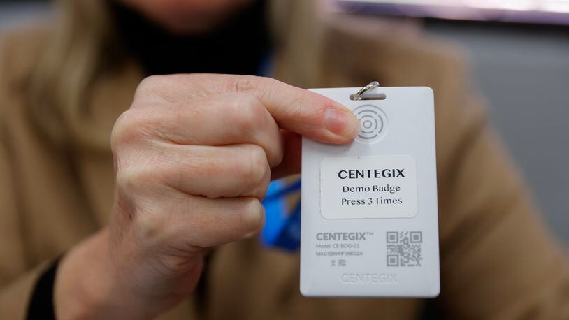 Centegix VP of marketing Stacy Myers holds up a demo crisis alert badge during a training at Findley Oaks Elementary School in Fulton County on Monday, March 20, 2023. Gwinnett County Public Schools is the latest metro Atlanta school district to adopt the technology. (Natrice Miller/ natrice.miller@ajc.com)
