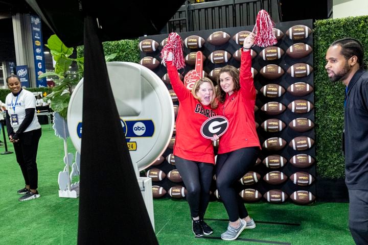 Michelle Cowan, from Charlotte, left, and Lindsey Verran, from Minneapolis, pose for a photo at the SEC FanFare in Atlanta on Friday, Dec. 1, 2023. Georgia and Alabama play for the SEC Championship Saturday at Mercedes-Benz Stadium.  (Ben Gray / Ben@BenGray.com)
