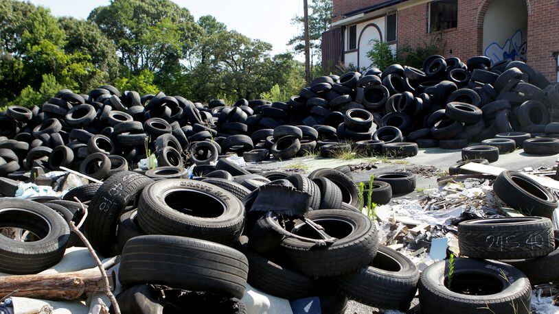 Illegally dumped tires have been a problem in Atlanta for years. Georgians pay a $1 disposal fee on each replacement tire they buy to fund cleanup of tire dumps, but the money hasn't always been spent that way. PHIL SKINNER / PSKINNER@AJC.COM