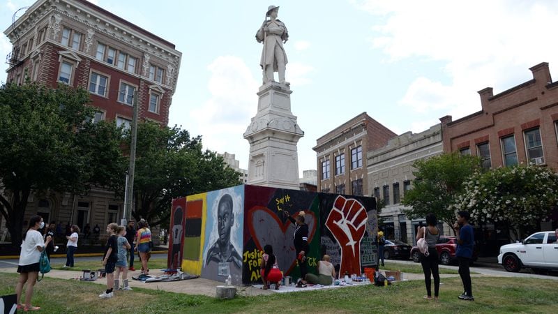 Macon, GA, 06/19/2020:
People paint a #BlockTheHate mural that was constructed around the Confederate monument at the corner of Cotton Avenue and Second Street on Friday. The mural was created to block the statue from being defaced while also promoting a positive message of love and unity until the statue can be removed. (JENNA EASON / THE TELEGRAPH)