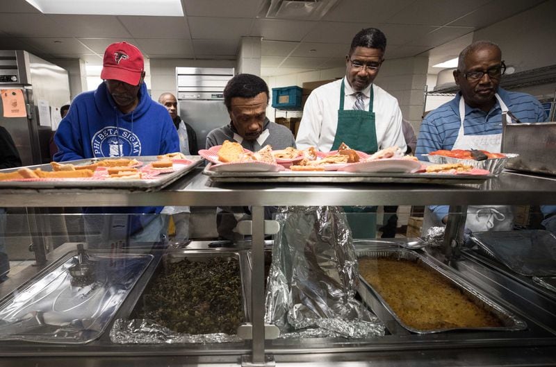 Antioch Baptist Church North Male Chorus members prepare a Thanksgiving meal at the Salvation Army on Nov. 15, 2018, in Atlanta.  BRANDEN CAMP/SPECIAL