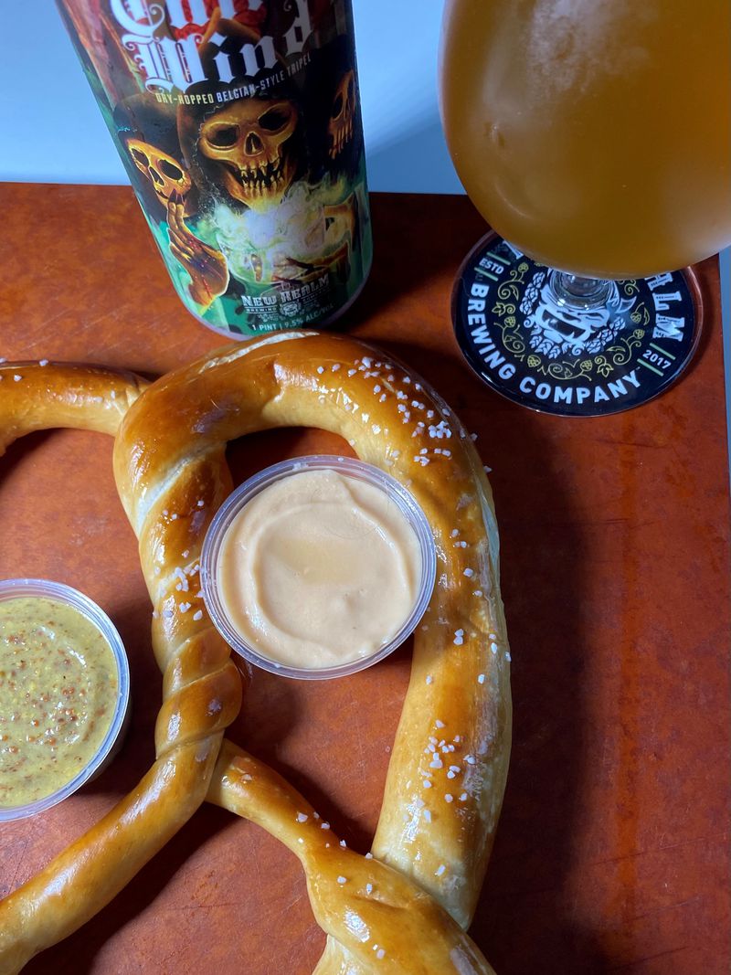New Realm's house-made, hand-twisted Bavarian pretzel comes with beer cheese and jalapeño mustard sauces. Bob Townsend for The Atlanta Journal-Constitution 
