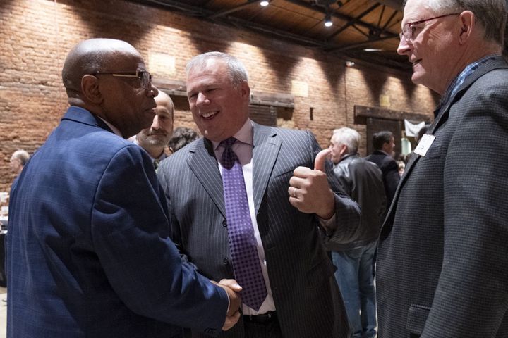 Former Rep. Mike Coan, center, greets Rep. Mack Jackson (D-Sandersville), left,  at the Wild Hog Supper, which is the traditional kick off to the legislative session in Atlanta on Sunday, Jan. 7, 2024. (Ben Gray / Ben@BenGray.com)