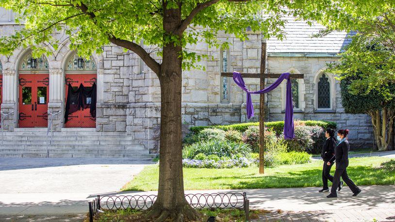 Saint Mark United Methodist Church on Peachtree Street has veiled one front door in observance of Good Friday on April 10, 2020. The veil also covers one of the posted messages that the church is closed until further notice. (Jenni Girtman for The Atlanta Journal-Constitution)