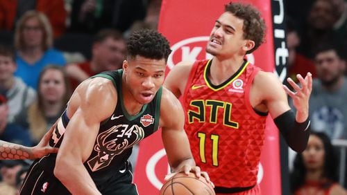 Atlanta Hawks guard Trae Young reacts as Milwaukee Bucks Giannis Antetokounmpo comes away with the defensive rebound during the first half in a NBA basketball game at State Farm Arena on Sunday, Jan. 13, 2019, in Atlanta.    Curtis Compton/ccompton@ajc.com