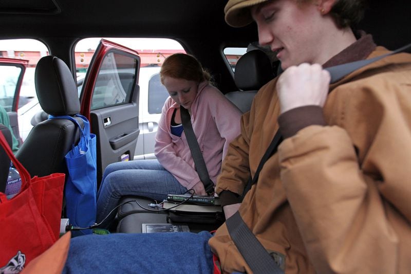 Adam Crail, 17, and his sister Rachel, 14, fasten their seat belts in the back of their parent's SUV at the Hinsdale Oasis in Hinsdale, Illinois. (Scott Strazzante/ Chicago Tribune/TNS)