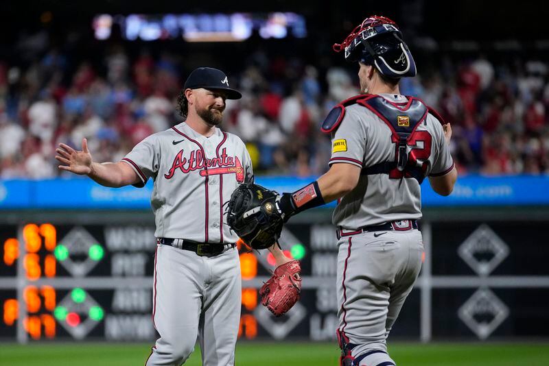 Atlanta Braves' Kirby Yates celebrates with Sean Murphy after the Braves clinched their sixth consecutive NL East title by defeating the Philadelphia Phillies in a baseball game, Wednesday, Sept. 13, 2023, in Philadelphia. (AP Photo/Matt Slocum)