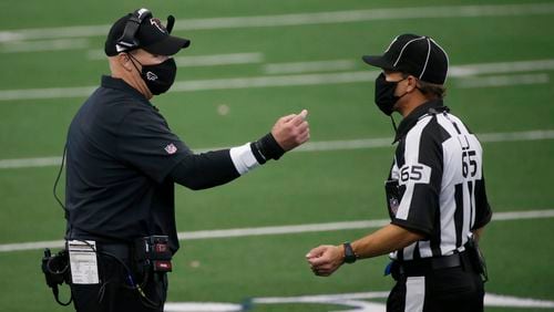 Falcons coach Dan Quinn talks with referee Walt Coleman (65) in the second half against the Dallas Cowboys on Sunday, Sept. 20, 2020, in Arlington, Texas. (Michael Ainsworth/AP)
