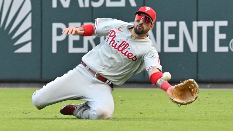 Phillies' Nick Castellanos makes a diving catch of William Contreras' line drive during the ninth inning of game one of the baseball playoff series between the Braves and the Phillies at Truist Park in Atlanta on Tuesday, October 11, 2022. (Hyosub Shin / Hyosub.Shin@ajc.com)