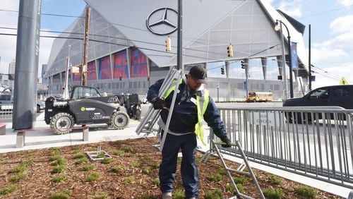 January 24, 2019 Atlanta - Javani Jaramillo, contractor, prepares to set up fences around the Mercedes-Benz Stadium near Vine City Transit Station on Thursday, January 24, 2019. HYOSUB SHIN / HSHIN@AJC.COM