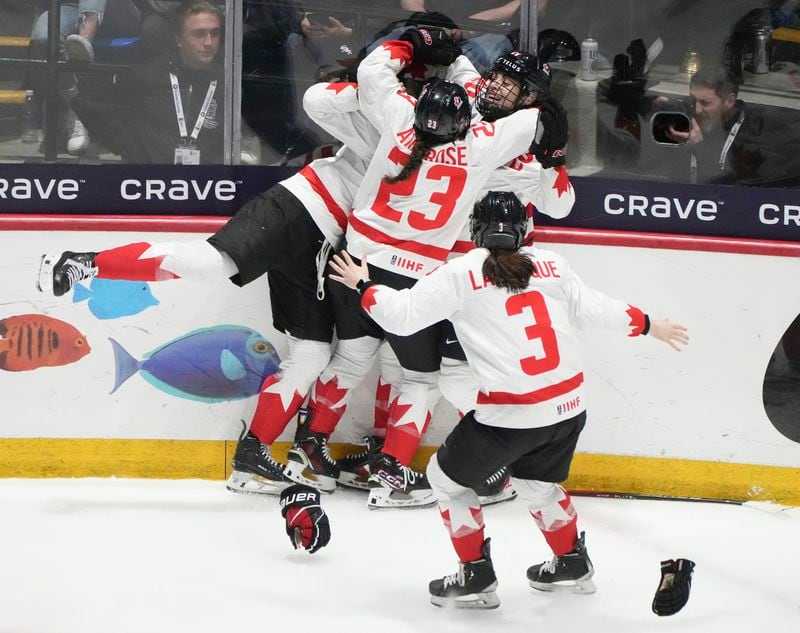 Canada's Danielle Serdachny celebrates her overtime goal over the United States with teammates in their gold medal game at the women's world hockey championships in Utica, N.Y., Sunday, April 14, 2024. (Christinne Muschi/The Canadian Press via AP)