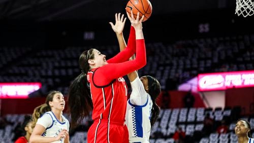 Georgia center Jenna Staiti (14) goes up and over to score against Kentucky in their last game at Stegeman Coliseum in Athens Thursday, Feb. 25, 2021. (Photo by Tony Walsh/UGA Athletics)
