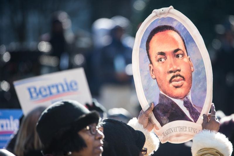 COLUMBIA, SC - JANUARY 18, 2016: woman holds a portrait of Rev. Dr. Martin Luther King during the King Day at the Dome rally at the S.C. State House January 18, 2016 in Columbia, South Carolina. The event drew appearances from Democratic presidential candidates Sen. Bernie Sanders, I-Vt, former Maryland Gov. Martin O'Malley and Hillary Clinton. (Photo by Sean Rayford/Getty Images)