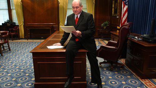 In this 2003 file photo, Gov. Sonny Perdue does his first official business as Georgia's new governor by reviewing some executive orders (which he signed later in the Senate chamber) in his new office at the Capitol.   After his inauguration ceremony at Philips, Perdue rode by car halfway to the Capitol and then walked the final distance with his wife, Mary. RICH ADDICKS/STAFF