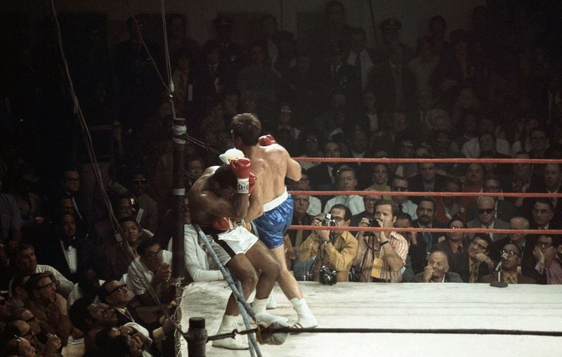 Muhammad Ali is against the ropes in the third round bout with Jerry Quarry at the Atlanta Municipal Auditorium on Oct. 26, 1970. Ali was declared the winner when the referee stopped the fight after Quarry was unable to answer the bell for the fourth round. Quarry had a cut over his left eye from a right hook from Ali, which came in the second round of this scheduled 15-round non-title fight. AP/file photo