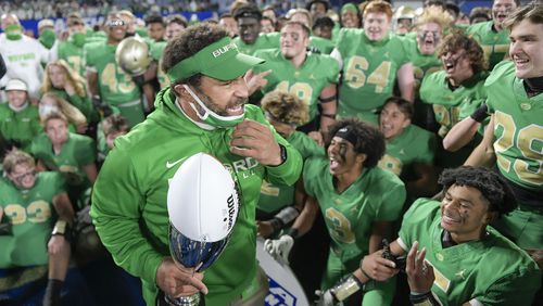 Buford head coach Bryant Appling holds his championship trophy after beating Lee County 34-31 in a Class 6A state high school football final Tuesday, December 29, 2020 in Atlanta. (PHOTO/Daniel Varnado)
