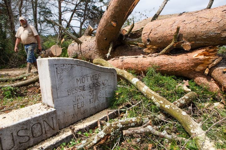 Debris left from a tornado surround a headstone at Northview Cemetary, on Friday, March 26, 2021, in Cedartown, Georgia. The storm caused severe damage in several areas throughout the town, but no casualties were reported.  CHRISTINA MATACOTTA FOR THE ATLANTA JOURNAL-CONSTITUTION.