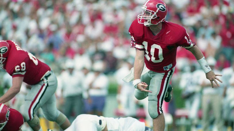 Former Georgia QB Eric Zeier set 67 school records and 18 SEC records when he played for the Bulldogs from 1991 to 1994. He also was the SEC's all-time passing leader after his career ended and he had a single-game high of 544 yards passing against Southern Miss in 1993. He's now a color analyst on UGA broadcasts. Take a look at images from Zeier's career. (Photo by Joey Ivansco / AJC)