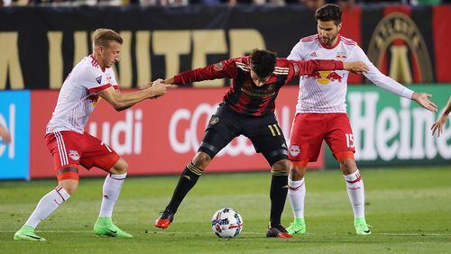 Atlanta United RC Yamil Asad is double-teamed by Daniel Royer (left) and Sal Zizzo of the New York Red Bulls during their first game Sunday, March 5, 2017, in Atlanta. Curtis Compton/ccompton@ajc.com