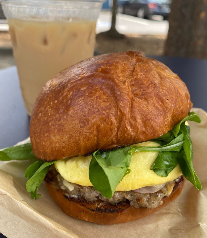 An iced coffee and breakfast sandwich from Kinship are a fine way to start the day. Ligaya Figueras/ligaya.figueras@ajc.com