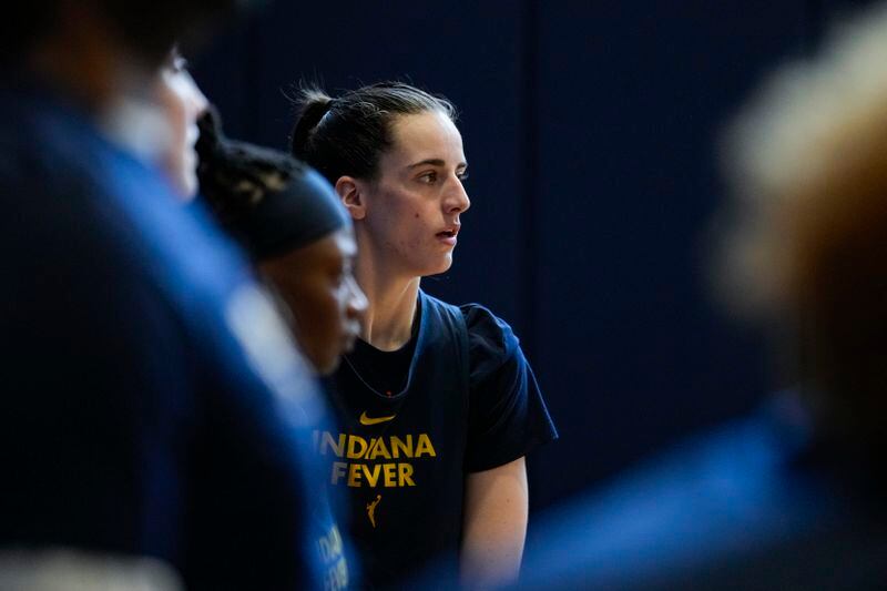 Indiana Fever guard Caitlin Clark watches from the sideline as the WNBA basketball team practices in Indianapolis, Sunday, April 28, 2024. (AP Photo/Michael Conroy)