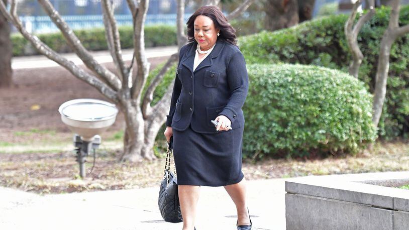 Former DeKalb County Commissioner Sharon Barnes Sutton walks towards county courthouse for a hearing by Superior Court Judge Asha Jackson on Tuesday. Sutton is suing the board, alleging that it’s unconstitutional because some of its members are appointed by community organizations instead of by elected officials. HYOSUB SHIN / HSHIN@AJC.COM