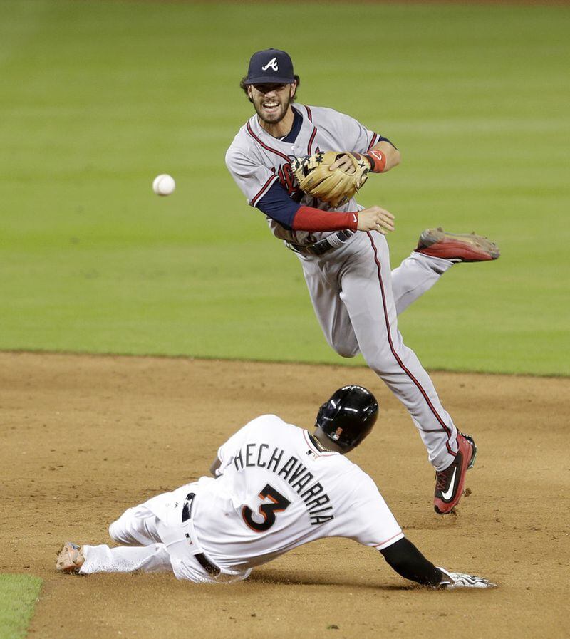  Braves shortstop Dansby Swanson (2) forces out the Marlins' Adeiny Hechavarria (3) on a ground ball fielder's choice by Ichiro Suzuki in the ninth inning of a baseball game, Thursday, Sept. 22, 2016, in Miami. Suzuki was safe at first base. (AP Photo/Alan Diaz)