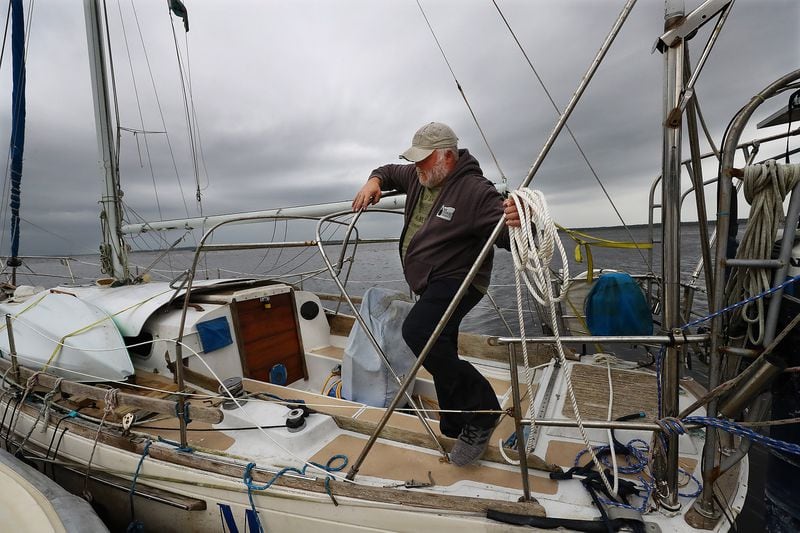 Dana Burchatz, 57, works to secure his 34-foot Morgan sailboat he recently purchased to the dock at Lang’s Marina hoping for the best while preparing for Hurricane Ian on Wednesday, Sept. 28, 2022, in St. Mary’s.  (Curtis Compton / Curtis Compton@ajc.com)